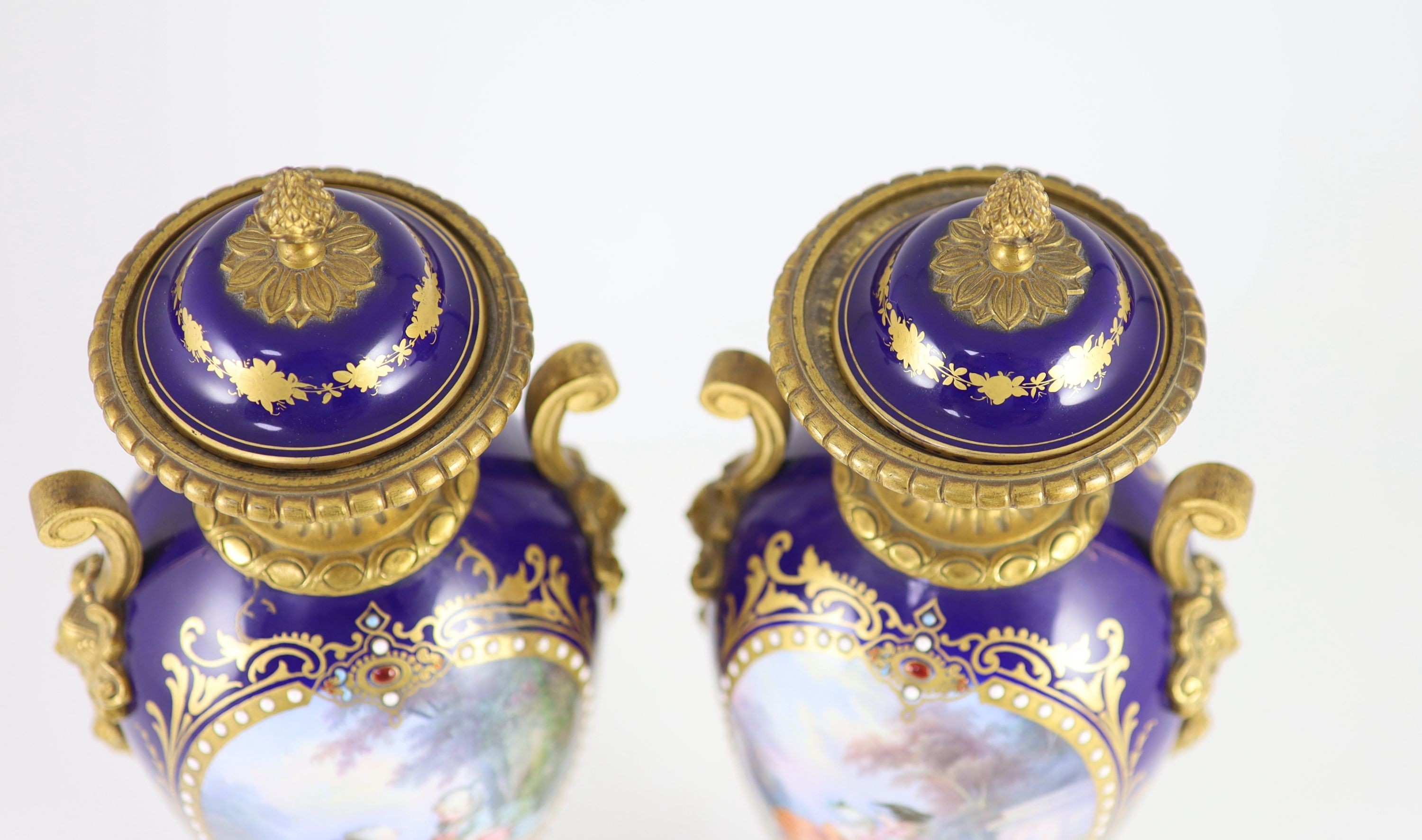 A pair of Sevres style ‘jewelled’ porcelain and ormolu mounted vases, c.1900, 41.5 cm high, one vase cracked